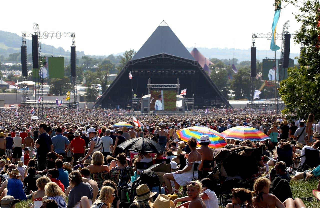 GLASTONBURY, ENGLAND - JUNE 23: The Glastonbury Festival crowd celebrate England's goal on a giant screen during their World Cup match that is being shown on the main stage screens at Worthy Farm, Pilton on June 23, 2010 in Glastonbury, England. The gates opened this morning at 8am to what has become Europe's largest music festival and is celebrating its 40th anniversary. (Photo by Matt Cardy/Getty Images)