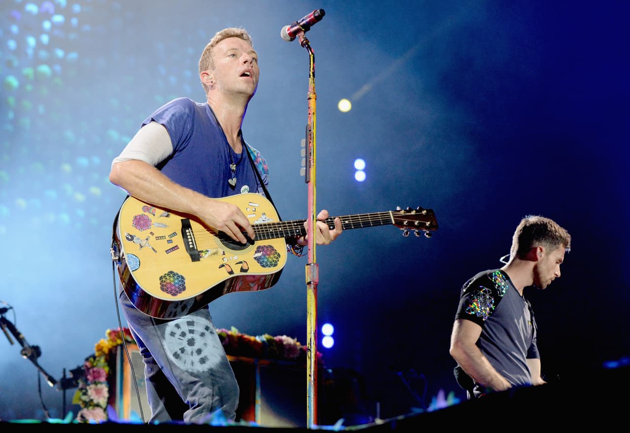 EAST RUTHERFORD, NJ - JULY 17: Recording artists Chris Martin (L) and Guy Berryman of Coldplay perform onstage during the Coldplay "A Head Full of Dreams" Tour at MetLife Stadium on July 17, 2016 in East Rutherford, New Jersey. (Photo by Kevin Mazur/Getty Images for Atlantic Records)