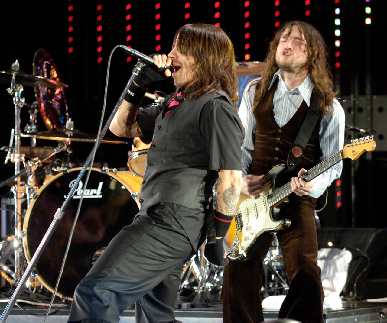 Anthony Kiedis, left, and guitarist John Frusciante of the band The Red Hot Chili Peppers perform during their headlining set at the annual day-long KROQ Weenie Roast summer concert in Irvine, Calif., Saturday, May 13, 2006. (AP Photo/Chris Pizzello)