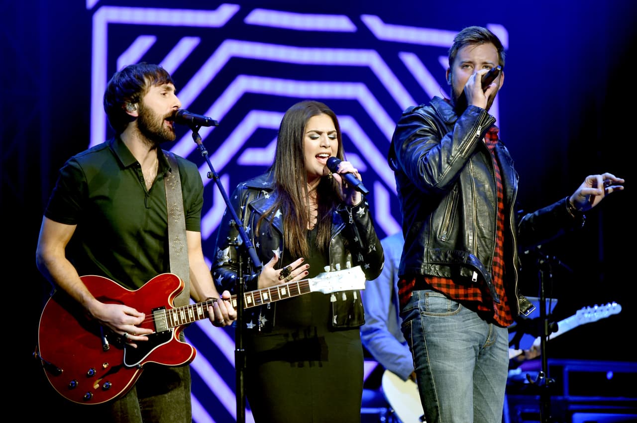 NASHVILLE, TN - NOVEMBER 12: In this handout photo provided by The Country Rising Fund of The Community Foundation of Middle Tennessee, (L-R) Singers Dave Haywood, Hillary Scott, and Charles Kelley of Lady Antebellum perform onstage for the Country Rising Benefit Concert at Bridgestone Arena on November 12, 2017 in Nashville, Tennessee. (Photo by John Shearer/Country Rising/Getty Images)