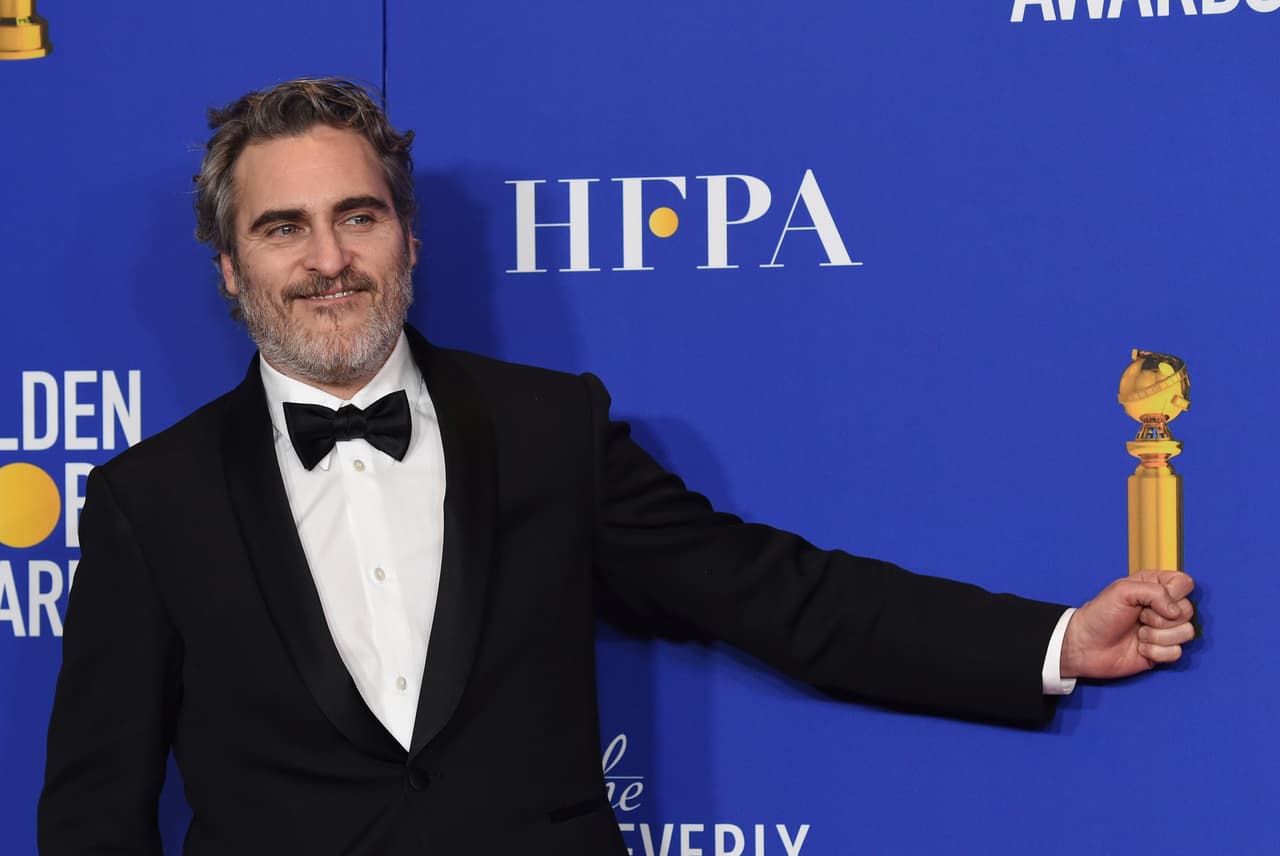 Joaquin Phoenix pretends to hold his award for best performance by an actor in a motion picture drama for "Joker" in the press room at the 77th annual Golden Globe Awards at the Beverly Hilton Hotel on Sunday, Jan. 5, 2020, in Beverly Hills, Calif. (AP Photo/Chris Pizzello)