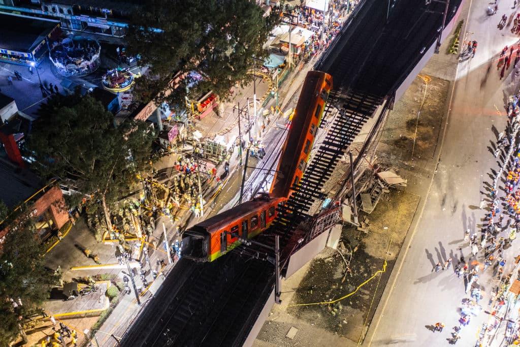 MEXICO CITY, MEXICO - MAY 03: An aerial view of the scene after an elevated section of metro track in Mexico City, carrying train cars with passengers, collapsed onto a busy road on May 03, 2021 in Mexico City, Mexico. The Line 12 accident happened as the metro train was traveling between Olivos and Tezonco Metro stations, reportedly killing at least 20 people and injuring further 70. (Photo by Hector Vivas/Getty Images)