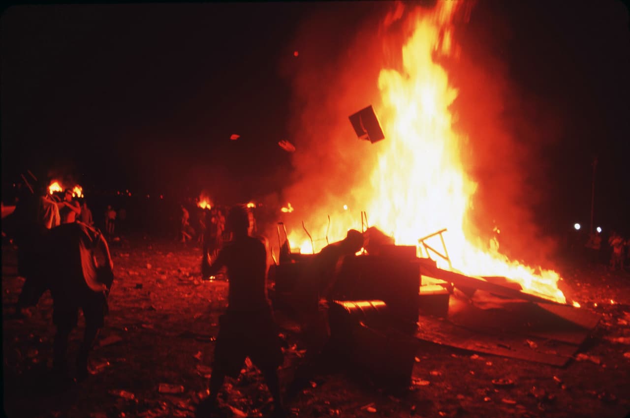 (Original Caption) Huge fires were lit, young people flung anything they could find into the fires. (Photo by Andrew Lichtenstein/Sygma via Getty Images)