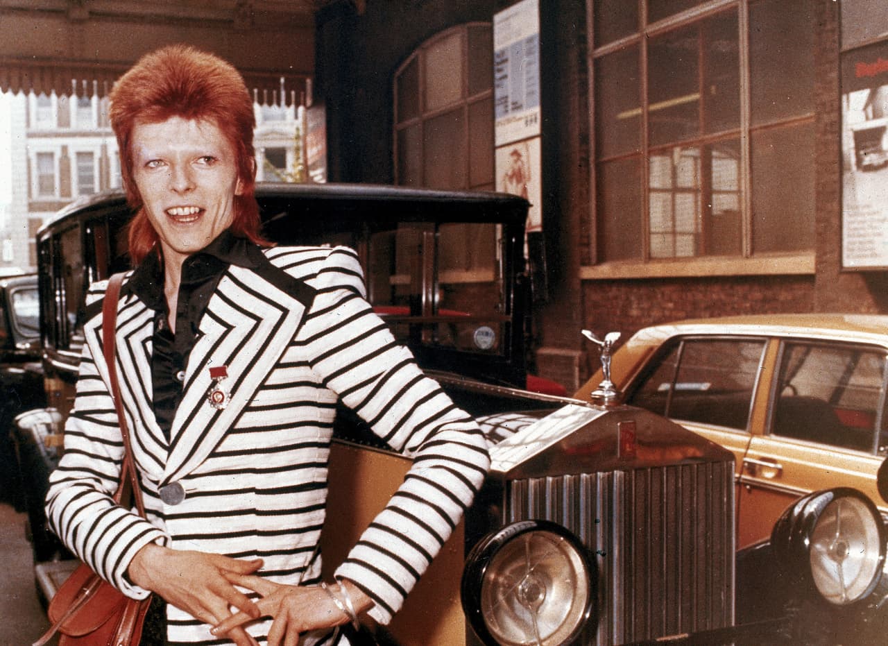 British rock singer, David Bowie, poses beside his Rolls Royce in May 1973. (AP Photo)