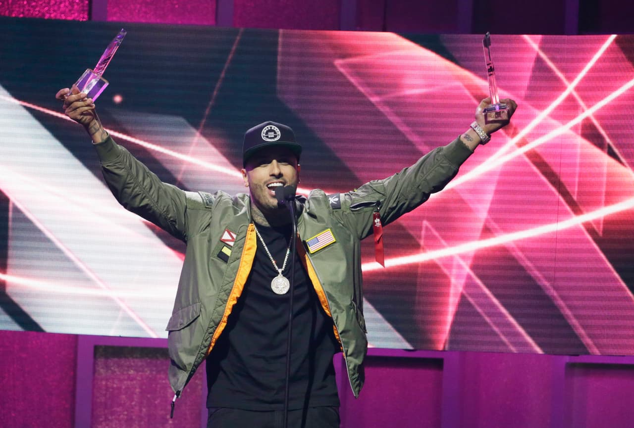 Singer Nicky Jam, raises his award for Latin Rhythm Song of the Year, at the Latin Billboard Awards, Thursday, April 27, 2017 in Coral Gables, Fla. (AP Photo/Lynne Sladky)