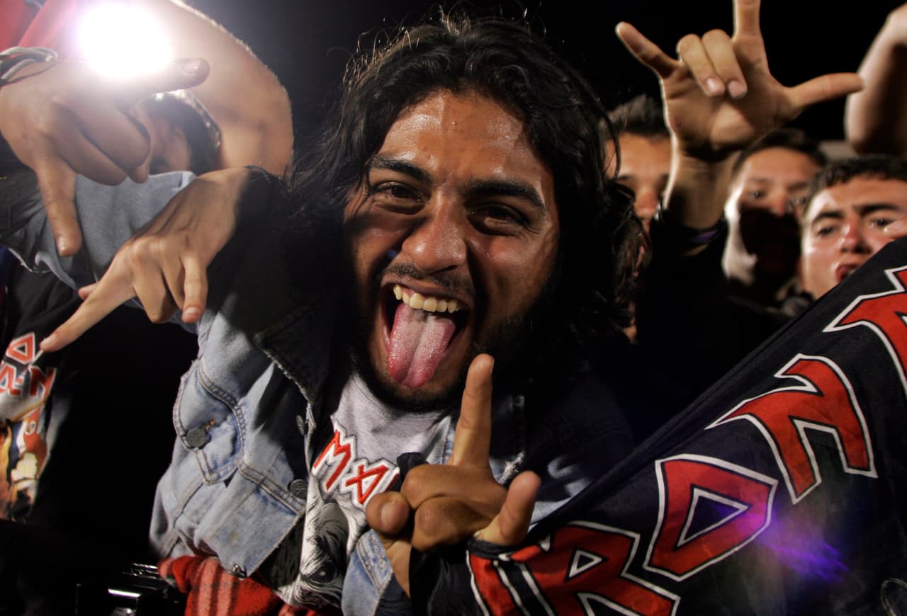 Fans of heavy metal rock band Iron Maiden scream at the band's "Somewhere Back In Time" tour in Alajuela, Costa Rica, Tuesday, March 3, 2009. (AP Photo/Kent Gilbert)