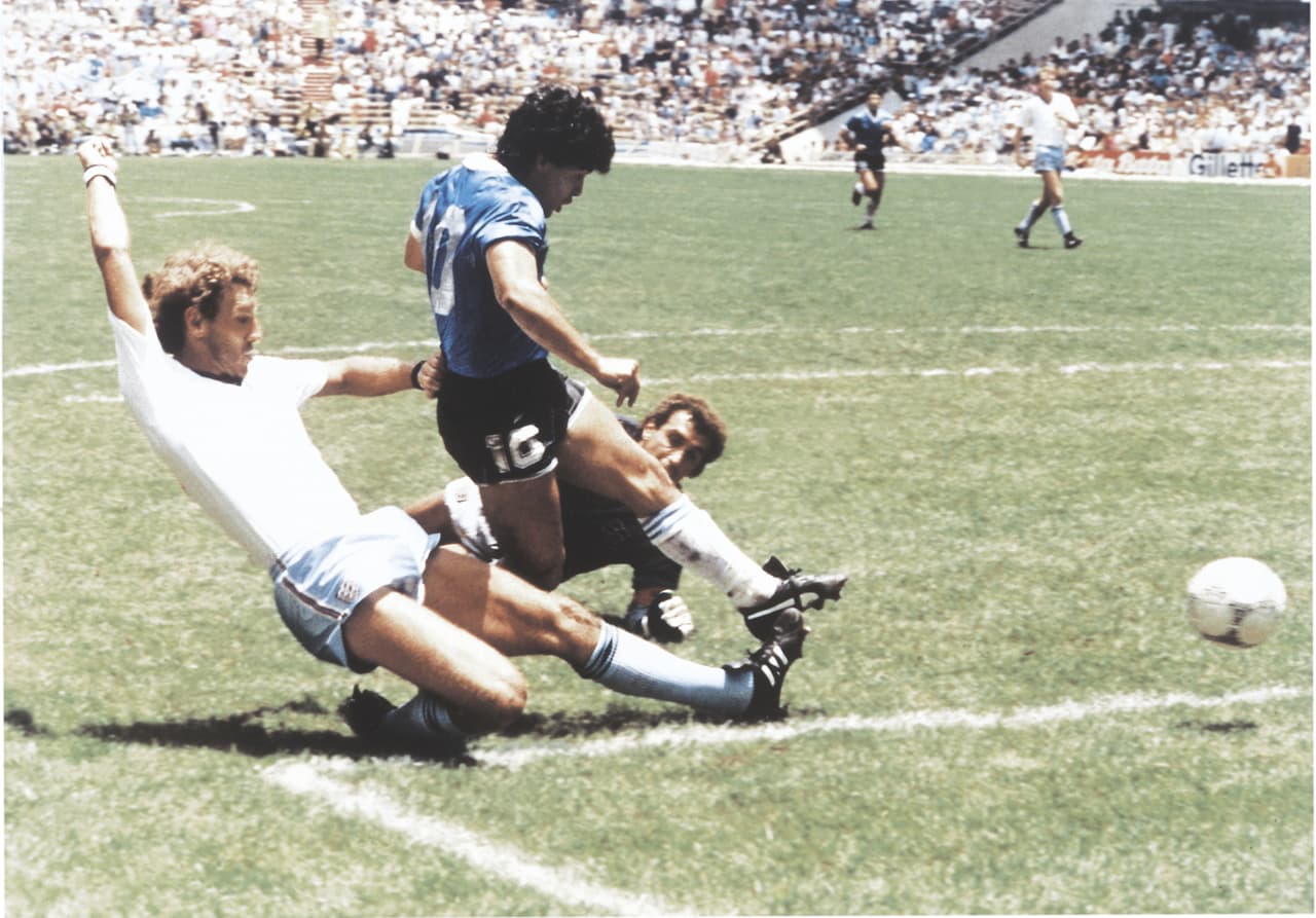 MEXICO CITY, MEXICO - JUNE 22: Diego Maradona of Argentina kicks the ball to score the second goal of his team during a 1986 FIFA World Cup Quarter Final match between Argentina and England at Azteca Stadium on June 22, 1986 in Mexico City, Mexico. (Photo by Archivo El Grafico/Getty Images)