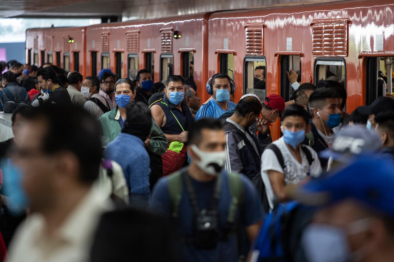 MEXICO CITY, MEXICO - APRIL 17: Commuters wearing face masks hope to board the Mexico City subway after authorities institute the mandatory use of face masks inside the subway on April 17, 2020 in Mexico City, Mexico. Mexico is under health emergency, which implies that only essential activities are permitted. Government suggested population to stay at home but quarantine is not obligatory as there is major concern about the economic activity. Hugo Lopez-Gatell Undersecretary of Prevention and Health Promotion announced the extension of the measures until at least, May 30 in those cities with a bigger risk and number of contagion. (Photo by Cristopher Rogel Blanquet/Getty Images)
