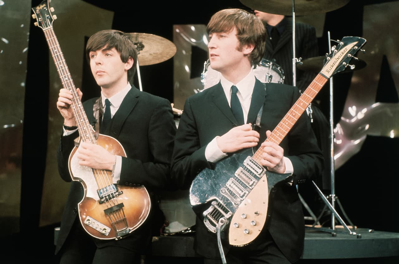 Paul McCartney and John Lennon hold their guitars while on the set of The Ed Sullivan Show at the CBS television studios in Manhattan, where the Fab Four are performing their nationwide television debut.