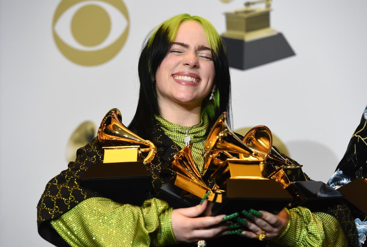 Billie Eilish poses in the press room with the awards for best album and best pop vocal album for "We All Fall Asleep, Where Do We Go?", best song and record for "Bad Guy" and best new artist at the 62nd annual Grammy Awards at the Staples Center on Sunday, Jan. 26, 2020, in Los Angeles. (AP Photo/Chris Pizzello)