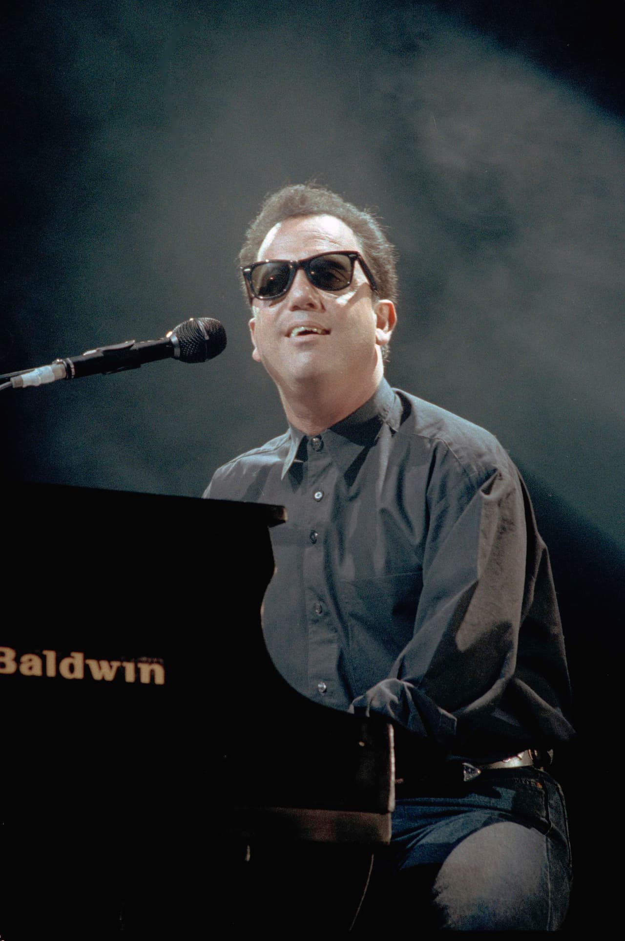Billy Joel plays for the crowd at Yankee Stadium in the Bronx section of New York, June 22, 1990. (AP Photo/Ed Bailey)