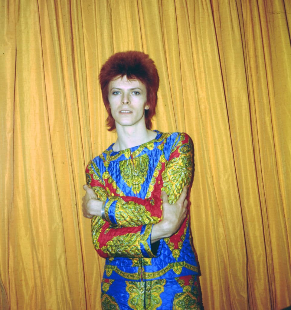 NEW YORK - 1973: Rock and roll musician David Bowie poses for a portrait dressed as 'Ziggy Stardust' in a hotel room in 1973 in New York City, New York. (Photo by Michael Ochs Archives/Getty Images)