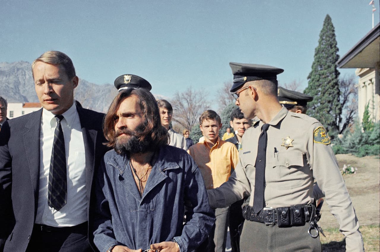 Charles Manson, leader of a hippie cult linked to the Sharon Tate murders, strides from jail to courtroom at Independence, Calif., Dec. 3, 1969, for a preliminary hearing on charges of possessing stolen property. (AP Photo)