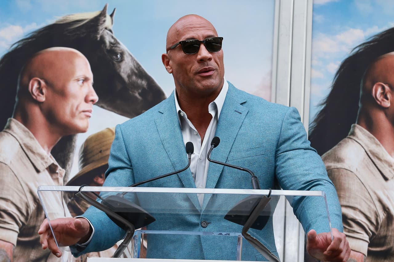 HOLLYWOOD, CALIFORNIA - DECEMBER 10: Dwayne Johnson speaks during Hand And Footprint Ceremony honoring Kevin Hart at TCL Chinese Theatre on December 10, 2019 in Hollywood, California. (Photo by Leon Bennett/WireImage)