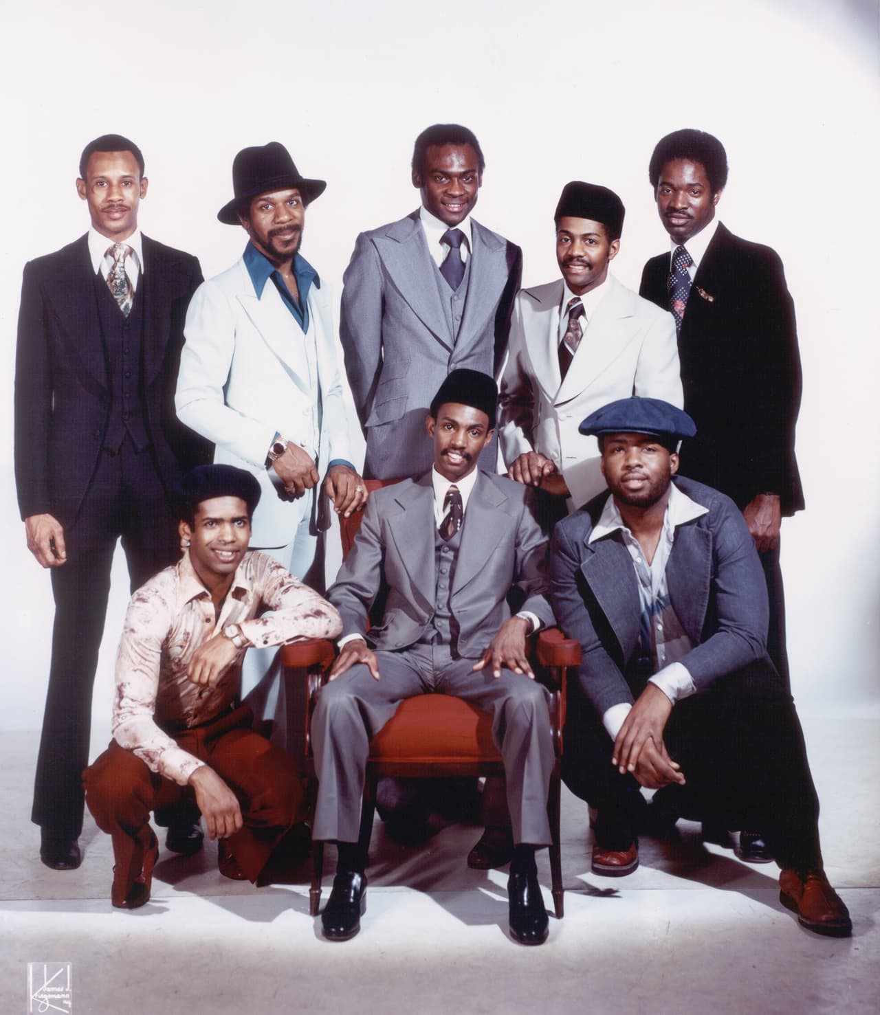 NEW YORK - CIRCA MID 1970s: R&B group "Kool & the Gang" pose for a mid 1970's portrait at the Kriegsmann studios in New York City. Robert Bell (known as "Kool") on bass (b. October 8, 1950, Youngstown, Ohio) and Ronald Bell on tenor saxophone (b. November 1, 1951, Youngstown, Ohio); George Brown on drums (b. January 5, 1949); Robert Mickens on trumpet; Dennis Thomas on alto saxophone; Claydes Charles Smith on guitar (b. September 6, 1948, d. June 20, 2006), trombonist Clifford Adams, and Rick Westfield on keyboards. (Photo by James Kriegsmann/Michael Ochs Archives/Getty Images)