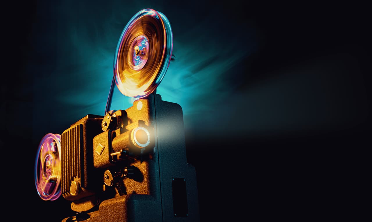 Vintage old fashioned projector in a dark room projecting a film, cinematography concept