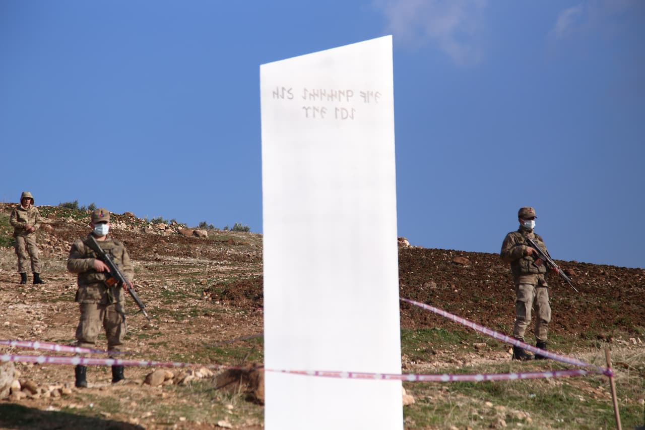 SANLIURFA, TURKEY - FEBRUARY 06: Soldiers stand guard near a monolith, triangular in shape and metallic in composition, appeared at the ancient site of Gobeklitepe, known as the world's oldest temple, in Sanliurfa, Turkey on February 06, 2021. Gobeklitepe is in the World Heritage List of UNESCO (The United Nations Educational, Scientific and Cultural Organization), and hosts thousands of visitors from many countries including Europe to Far East, from America to Africa. (Photo by Yasin Dikme/Anadolu Agency via Getty Images)
